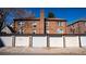 Exterior view of garages with brick facade and tiled roof at 1436 N Gilpin St # 2, Denver, CO 80218