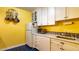 Bright, vintage style kitchen with white appliances, white cabinets, and yellow walls at 1436 N Gilpin St # 2, Denver, CO 80218