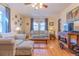 Bright living room with hardwood floors, neutral furniture, large windows, and a ceiling fan at 1436 N Gilpin St # 2, Denver, CO 80218