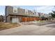 Exterior view of townhomes with brick facade, rock landscaping, and private fenced backyards at 1482 S Pierson St # 75, Lakewood, CO 80232