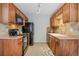 Functional kitchen with wooden cabinets, tile backsplash, and essential appliances at 1482 S Pierson St # 75, Lakewood, CO 80232