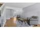 Open living area with hardwood floors, neutral decor, and view into dining space at 1482 S Pierson St # 75, Lakewood, CO 80232