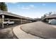 Exterior view of covered parking featuring assigned spots, a paved driveway, and well-maintained landscaping at 1482 S Pierson St # 75, Lakewood, CO 80232