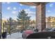 Relax on this balcony with brick pillar and beautiful mountain views with stylish patio seating and a black metal railing at 7865 Vallagio Ln # 207, Englewood, CO 80112