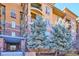 Attractive condo building with brick and stucco exterior and nicely landscaped entrance at 7865 Vallagio Ln # 207, Englewood, CO 80112