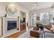 Inviting living room featuring a tiled fireplace, ceiling fan, and neutral tones at 7865 Vallagio Ln # 207, Englewood, CO 80112