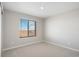 Bright bedroom featuring a large window with views and neutral carpet at 9454 Yampa St, Commerce City, CO 80022