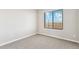 Cozy bedroom featuring a large window with views and neutral carpet at 9454 Yampa St, Commerce City, CO 80022