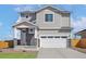 Charming two-story home with gray siding, stone accents, and a two-car garage in a Gathering-friendly neighborhood at 9454 Yampa St, Commerce City, CO 80022