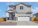 Charming two-story home featuring a two-car garage and stone accents at 9454 Yampa St, Commerce City, CO 80022