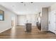 Open-concept living room and kitchen featuring hardwood floors and natural light at 9454 Yampa St, Commerce City, CO 80022
