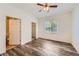 Cozy bedroom with wood-look flooring, ceiling fan, and a walk-in closet, providing comfort and ample storage space at 8481 W Union Ave # 2-103, Littleton, CO 80123