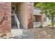 Condo exterior featuring brick accents, stairs leading to upper units, and rock landscaping, adding character and charm to the building at 8481 W Union Ave # 2-103, Littleton, CO 80123