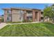 Inviting multi-story condo building with well-maintained lawn, complemented by tasteful landscaping and brick architectural accents at 8481 W Union Ave # 2-103, Littleton, CO 80123