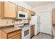 Functional kitchen featuring wood cabinets, ample counter space, and essential appliances, ready for culinary adventures at 8481 W Union Ave # 2-103, Littleton, CO 80123