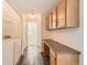 Convenient laundry room with built-in cabinets and countertop, providing a functional and organized space at 8481 W Union Ave # 2-103, Littleton, CO 80123