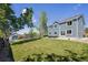 Large backyard with lush lawn, storage shed, and trampoline in fenced area at 12277 Krameria St, Brighton, CO 80602