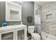 Bathroom features updated vanity, toilet, and shower with modern gray and white tile at 12277 Krameria St, Brighton, CO 80602