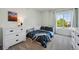 Bright bedroom with a large window, a comfortable bed, and a dresser at 12277 Krameria St, Brighton, CO 80602