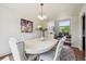 Bright dining room featuring an oval table, decorative chandelier, and an open view to the living room at 12277 Krameria St, Brighton, CO 80602