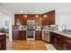 Modern kitchen featuring stainless steel appliances, granite countertops, and dark wood cabinets at 12277 Krameria St, Brighton, CO 80602