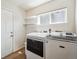 Convenient laundry room with appliances, window, and shelving at 12277 Krameria St, Brighton, CO 80602