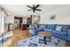 Open concept living room with eat-in kitchen and hardwood floors at 12277 Krameria St, Brighton, CO 80602