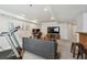 Spacious living room features modern decor, a workstation, and a treadmill at 12277 Krameria St, Brighton, CO 80602
