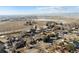 An aerial view of a charming neighborhood with a pond in the distance at 8280 E 104Th Way, Henderson, CO 80640