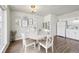 Dining room features modern lighting, a round table, decor, and wood laminate flooring at 8280 E 104Th Way, Henderson, CO 80640