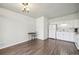 Kitchen and dining area with wood floors and white appliances at 8280 E 104Th Way, Henderson, CO 80640