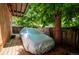 Backyard with a covered vehicle surrounded by trees and a wooden fence at 807 9Th St, Golden, CO 80401