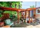 Backyard featuring a covered porch and charming brick patio surrounded by lush greenery at 807 9Th St, Golden, CO 80401