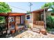 Backyard featuring a covered porch and charming brick patio surrounded by greenery and potted plants at 807 9Th St, Golden, CO 80401