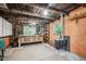 Basement with work area, exposed wood beams, painted walls and a wood-burning stove at 807 9Th St, Golden, CO 80401