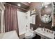 Cozy bathroom featuring a vintage sink, ornate mirror, and a shower with white subway tile at 807 9Th St, Golden, CO 80401