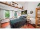 Cozy bedroom featuring a comfortable bed, natural light from the windows, and unique decorative elements at 807 9Th St, Golden, CO 80401