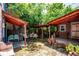 Outdoor courtyard featuring mature trees, brick pavers, and covered seating areas at 807 9Th St, Golden, CO 80401