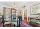 Eclectic dining room with glass table, red patterned rug and natural light at 807 9Th St, Golden, CO 80401