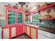 Quaint kitchen features vintage cabinets, colorful accents, and ample counter space at 807 9Th St, Golden, CO 80401