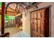 Covered patio with a rustic wooden door, decorative wheel and brightly colored seating at 807 9Th St, Golden, CO 80401