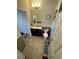 Well-lit bathroom featuring a vanity with a sink, tiled floors, and a shower with a curtain at 1489 Arapahoe St, Strasburg, CO 80136