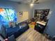 This bedroom is decorated with themes and features hardwood flooring at 1489 Arapahoe St, Strasburg, CO 80136