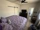 Spacious bedroom featuring a ceiling fan, barn door closet, wood floors and ensuite bath at 1489 Arapahoe St, Strasburg, CO 80136