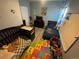 Bright and airy bedroom offering plenty of natural light and ample space for rest and play at 1489 Arapahoe St, Strasburg, CO 80136
