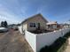 Charming single-Gathering home with a well-maintained yard and a white picket fence at 1489 Arapahoe St, Strasburg, CO 80136