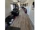 Open-concept living room featuring wood floors, comfortable seating, and access to the kitchen at 1489 Arapahoe St, Strasburg, CO 80136