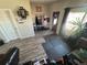 View of living area with wood-look floors, seating, storage, and a door with a window view at 1489 Arapahoe St, Strasburg, CO 80136