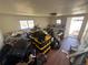Unkempt room filled with storage boxes and personal items, presenting an opportunity for decluttering and organization at 1489 Arapahoe St, Strasburg, CO 80136