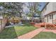 Large backyard featuring a patio, a deck and mature trees, ideal for outdoor activities at 6311 Xavier St, Arvada, CO 80003